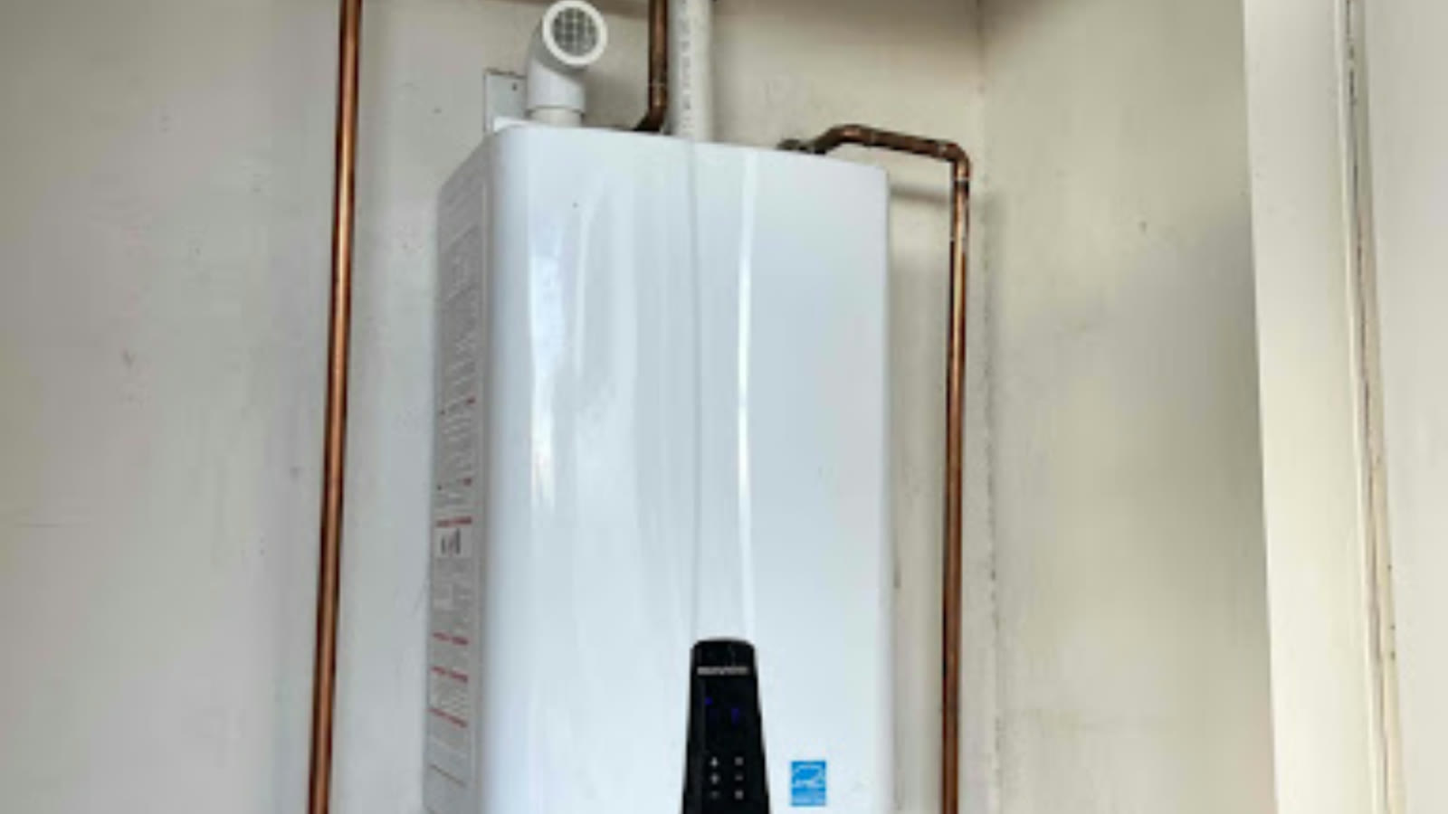 Residential water heater and copper supply piping in a Tempe utility room